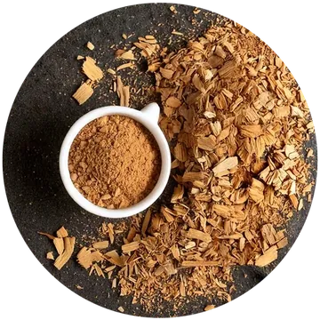 Muira puama bark chips beside a bowl of bark powder